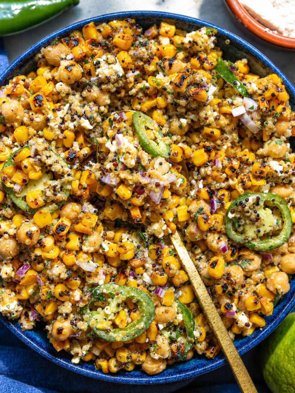 Spoonful of corn salad with quinoa, chickpeas, and feta.