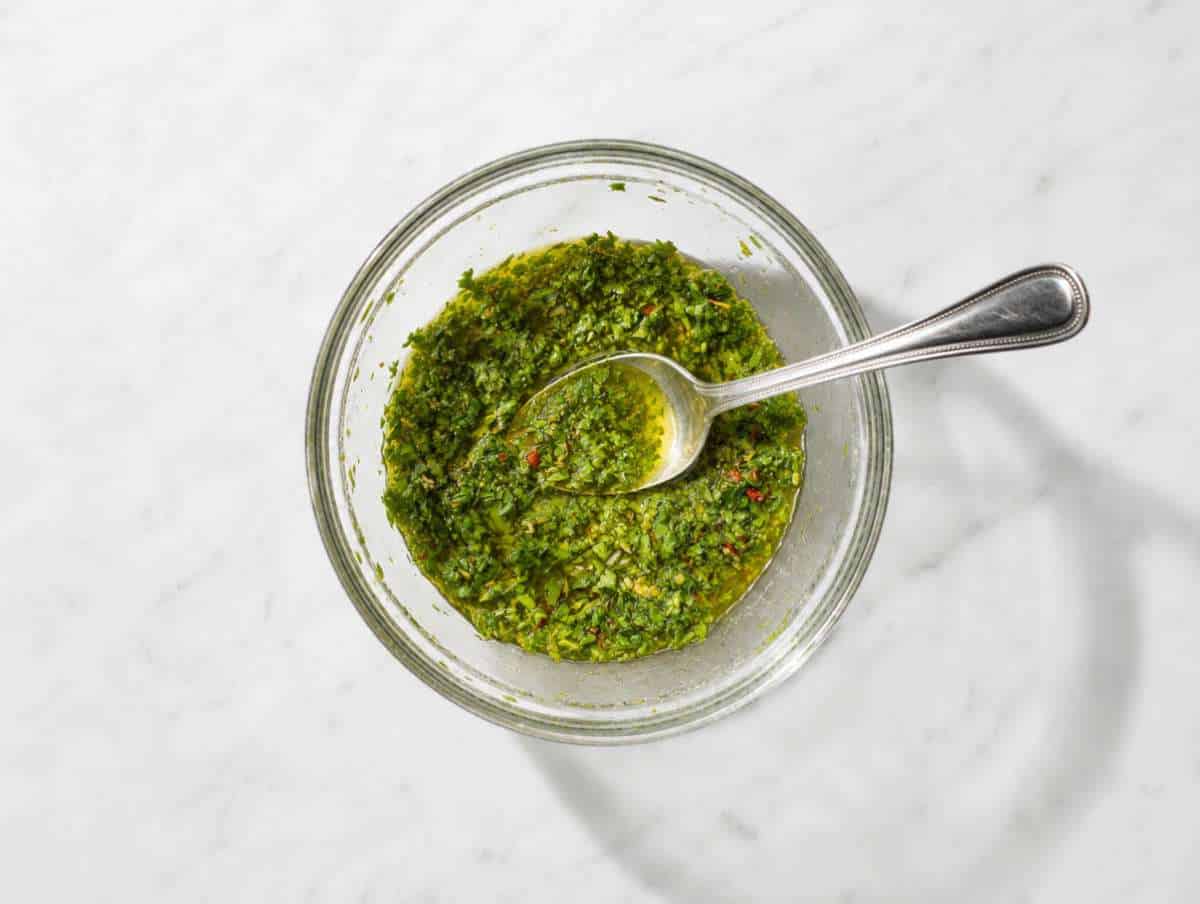 Step 1 Chopped parsley, olive oil, vinegar, garlic, and spices whisked into chimichurri dressing.