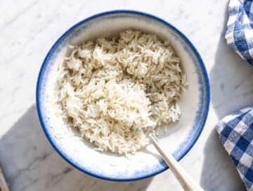 Step 1 Freshly cooked rice being mixed with sesame oil