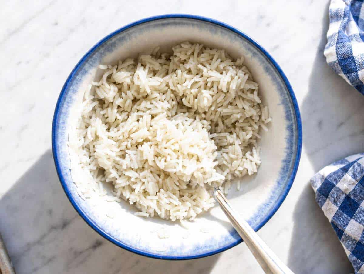 Step 1 Freshly cooked rice being mixed with sesame oil