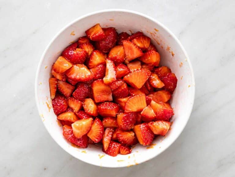Step 1 Strawberries mixed with honey and lemon zest releasing bright juicy syrup.
