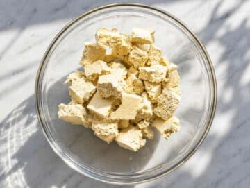 Step 1 Tearing firm tofu into rustic bite-size pieces.