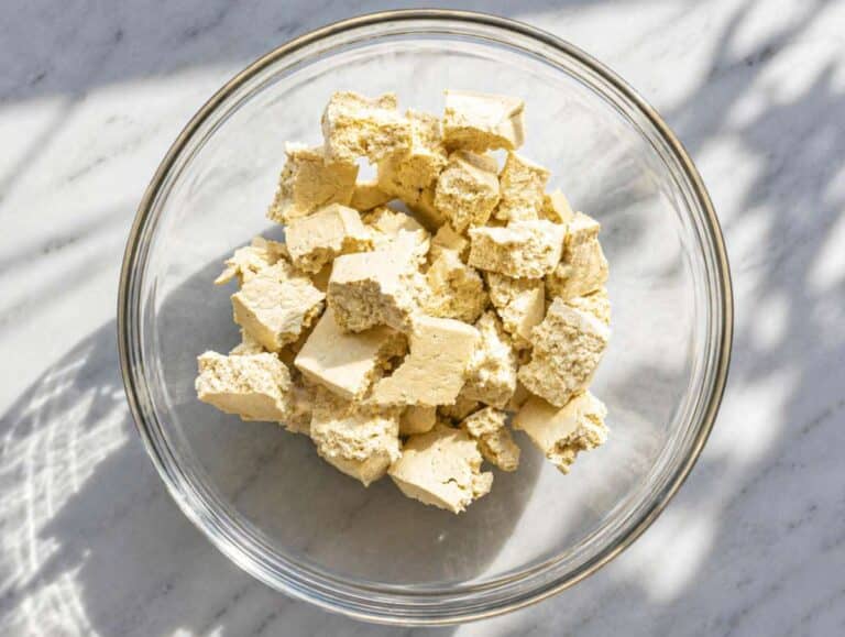 Step 1 Tearing firm tofu into rustic bite-size pieces.