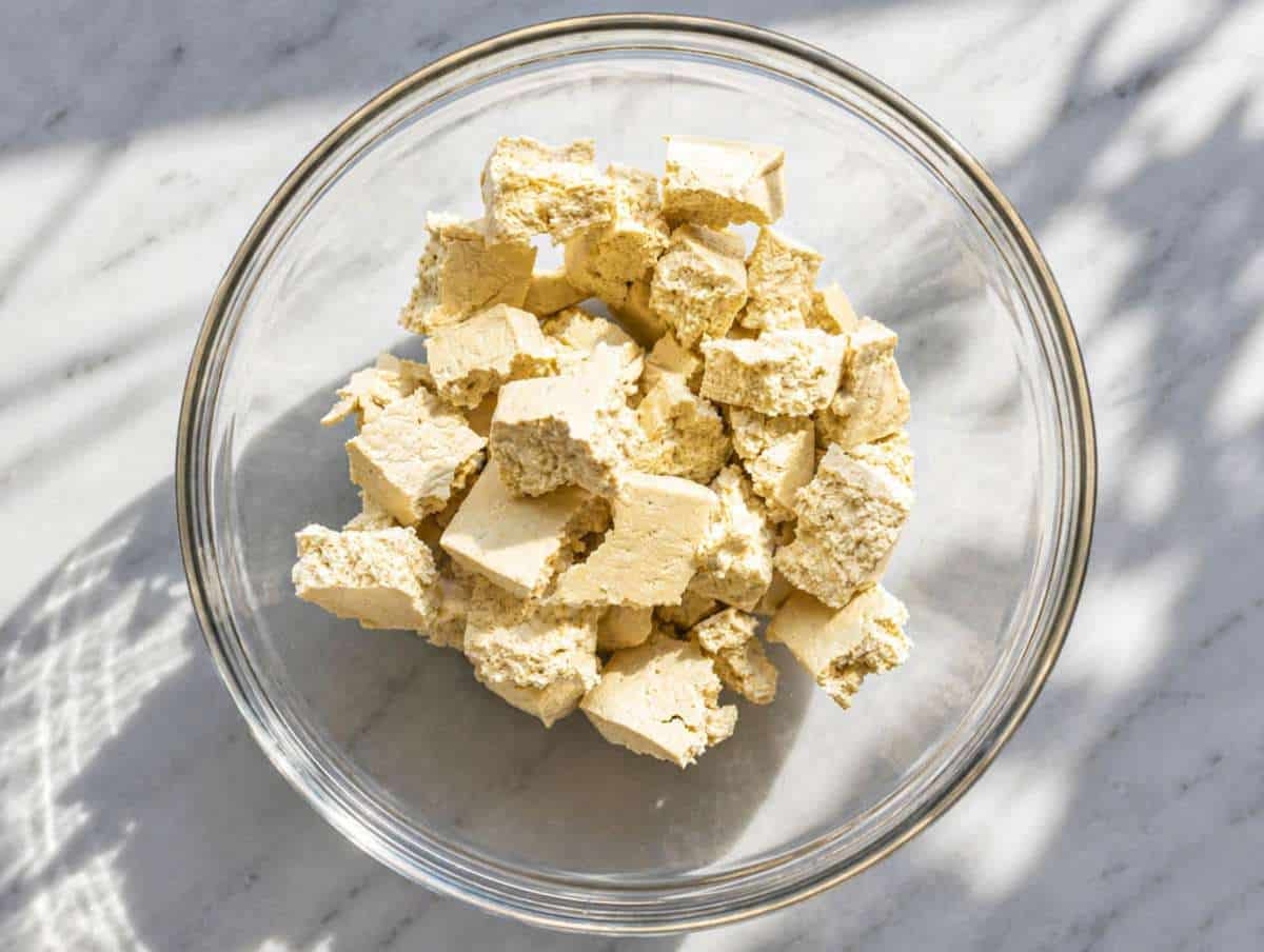 Step 1 Tearing firm tofu into rustic bite-size pieces.