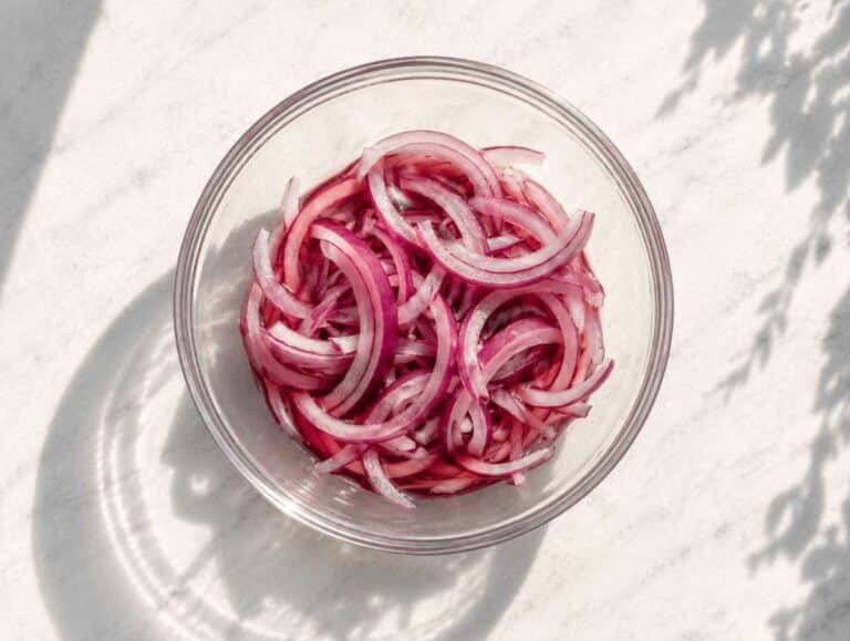 Step 1 thinly sliced red onion soaking in red wine vinegar in a small bowl.