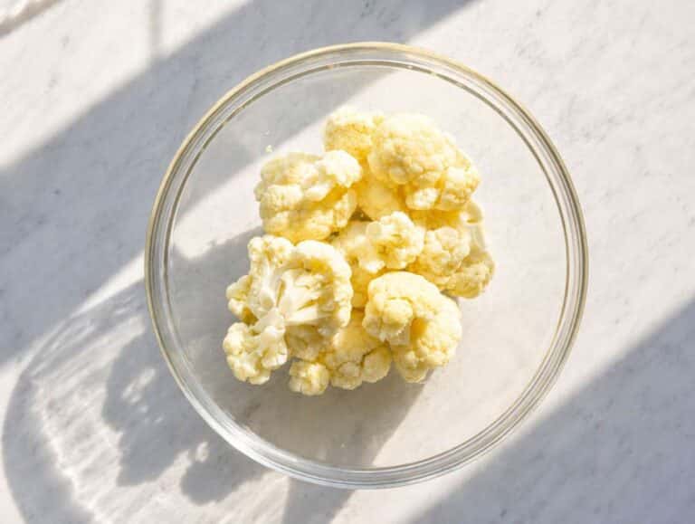 Step 2 Cauliflower florets in a glass bowl ready for quick microwave cooking.