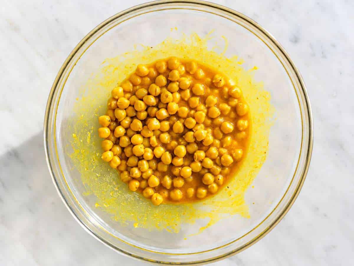 Step 2 Chickpeas coated evenly in golden turmeric dressing before marinating.