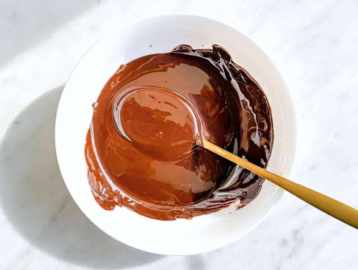 Step 2 Melted dark chocolate in small bowl, glossy texture.