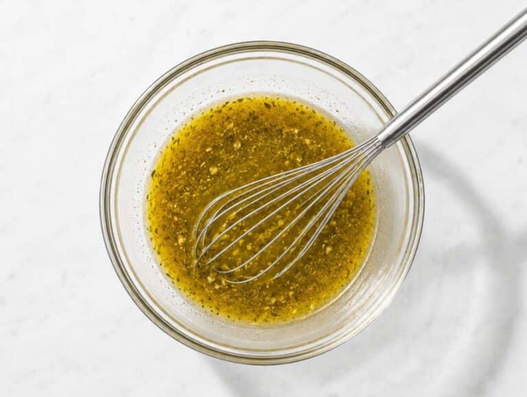 Step 2 Olive oil, vinegar, Dijon mustard, honey, garlic, and oregano whisked into a dressing.