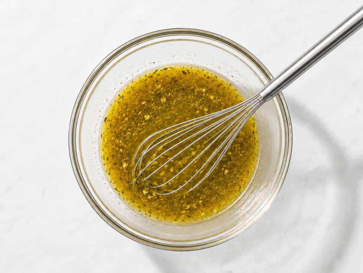 Step 2 Olive oil, vinegar, Dijon mustard, honey, garlic, and oregano whisked into a dressing.