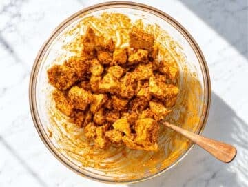 Step 2 Tofu pieces coated in shawarma marinade.