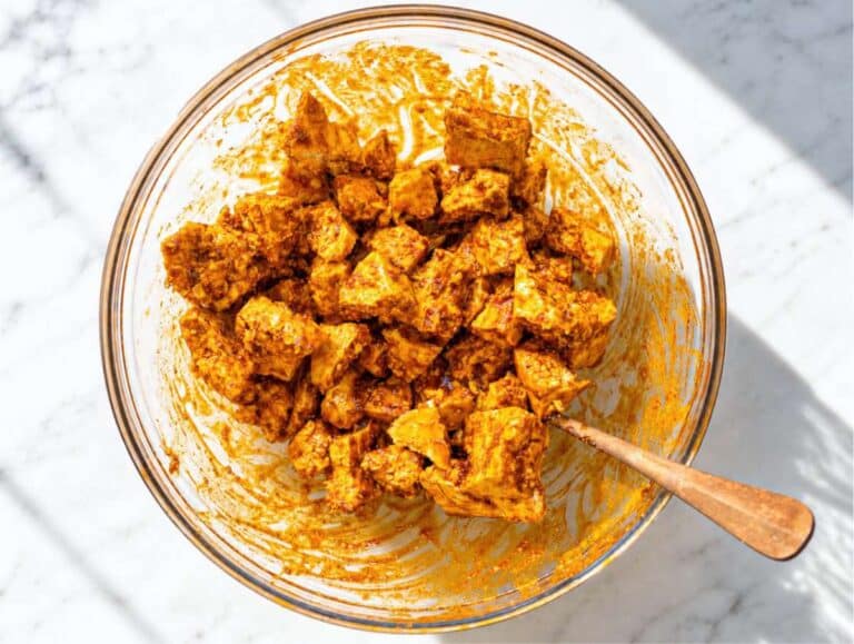 Step 2 Tofu pieces coated in shawarma marinade.