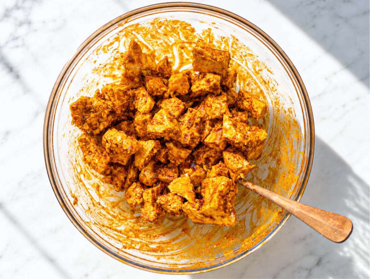 Step 2 Tofu pieces coated in shawarma marinade.