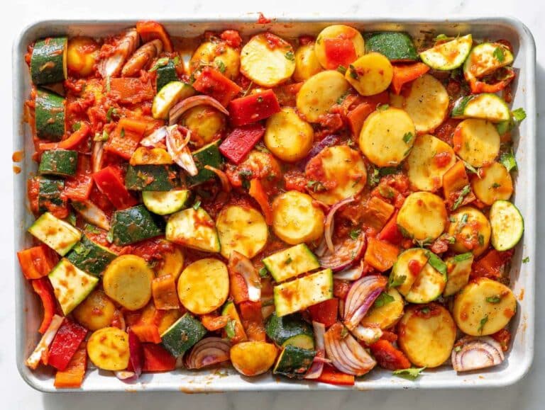 Step 2 Vegetables tossed with tomatoes, olive oil, garlic, and oregano before roasting.