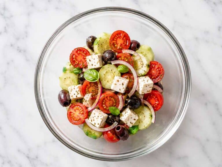 Step 3 Cucumber slices, cherry tomatoes, red onion, and Kalamata olives tossed with dressing