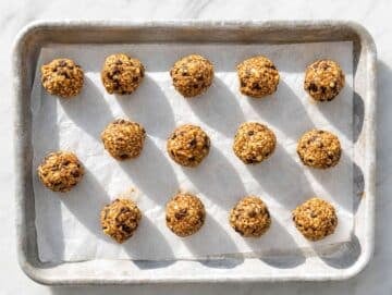 Step 3 Rolled chunky monkey energy balls on a baking tray.