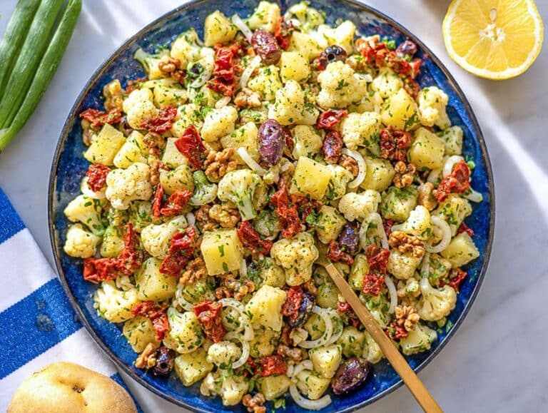 Step 4 Tossed potatoes, cauliflower, olives, walnuts, and herbs with the dressing.