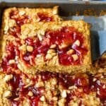Baked oatmeal squares with strawberry jam swirls and peanuts.