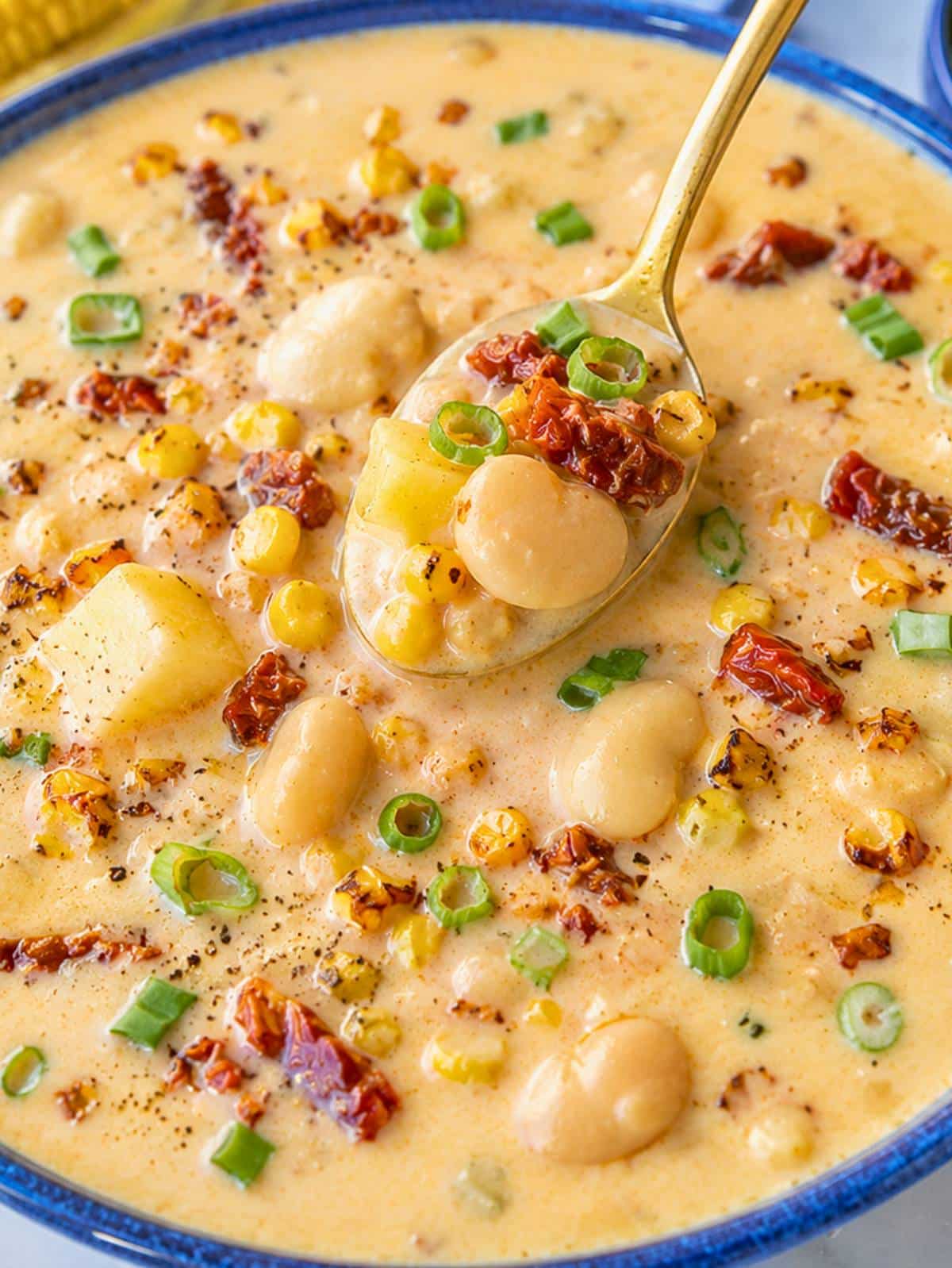 Close-up of creamy corn chowder with butter beans, potatoes, and sweet corn.