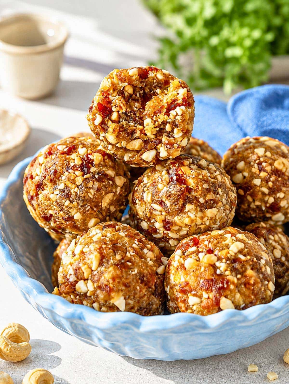 Close-up of energy ball showing chewy dates and crunchy cashew pieces.
