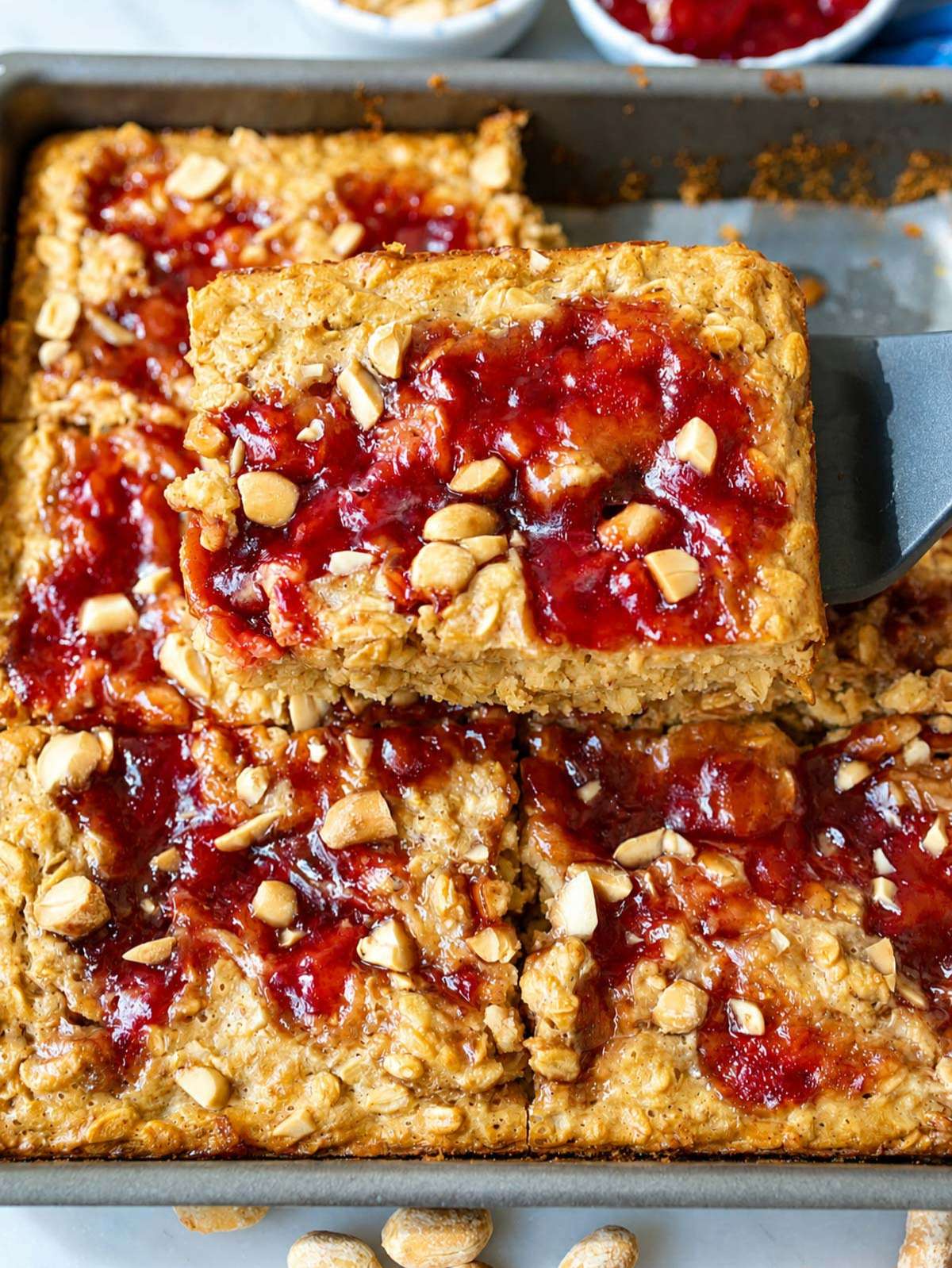 Close-up of moist oatmeal with glossy strawberry jam and creamy Greek yogurt.
