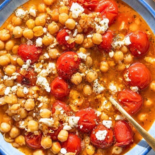 Glossy tomato chickpea soup with crumbled feta and oregano.