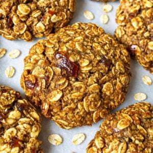 Healthy Oatmeal Date Cookies with date pieces on white baking paper.
