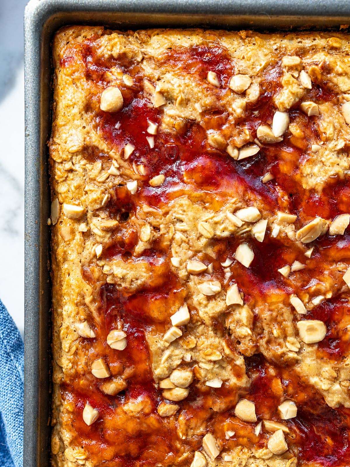 Peanut Butter and Jelly Baked Oatmeal with yogurt, jam, and chopped peanuts.
