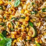 Roasted corn orzo with charred zucchini and feta in natural daylight.