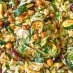 Sheet pan dinner of roasted zucchini orzo beside a bright window.
