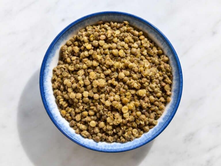 Step 1 French green lentils cooked until tender in a blue bowl.