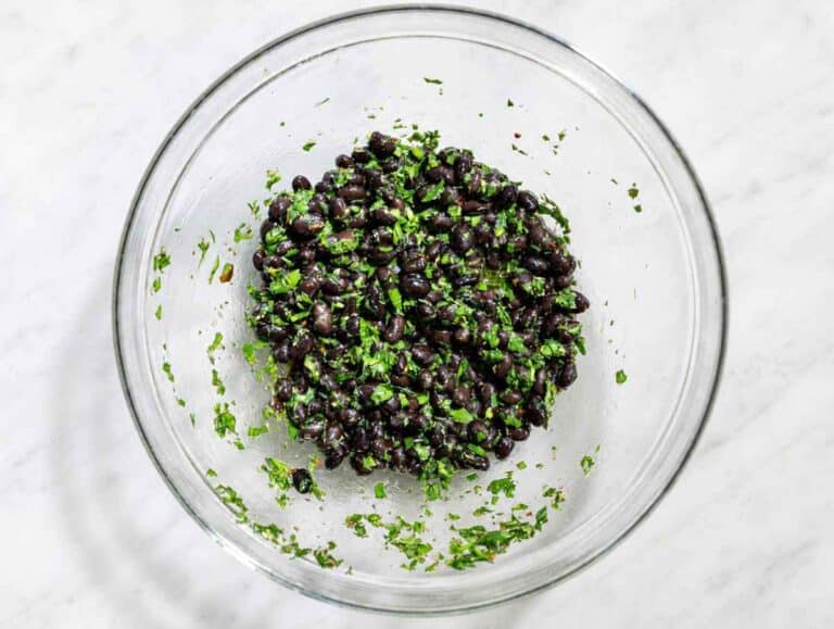 Step 1 Fresh chimichurri dressing mixed with black beans in a large glass mixing bowl.