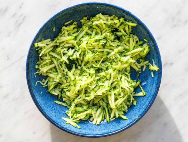 Step 1 Grated zucchini salted in a shallow bowl.