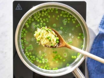 Step 1 Orzo and frozen peas cooking together in boiling salted water.