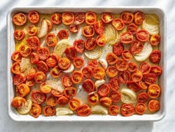 Step 1 Roasted tomatoes, caramelised onion, and garlic with bubbling pan juices.
