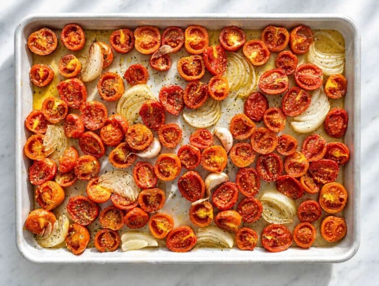 Step 1 Roasted tomatoes, caramelised onion, and garlic with bubbling pan juices.