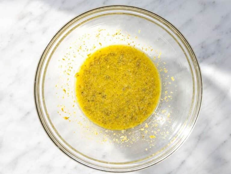 Step 1 Whisking lemon piccata dressing with olive oil, capers, Dijon, and garlic.