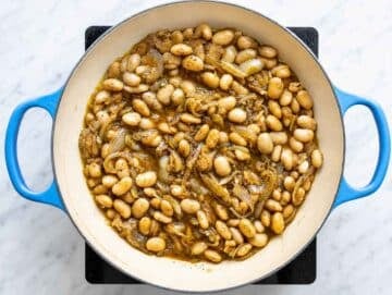 Step 2 Butter beans simmering with broth, garlic, thyme, and caramelized onions.