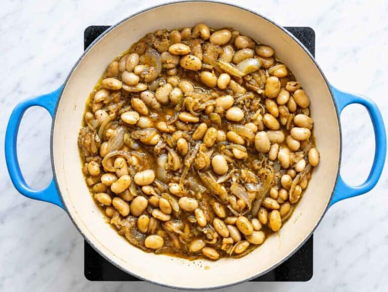 Step 2 Butter beans simmering with broth, garlic, thyme, and caramelized onions.