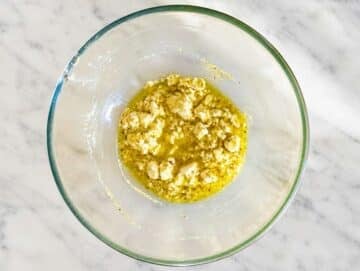 Step 2 Lemon dressing whisked with feta in a large mixing bowl.