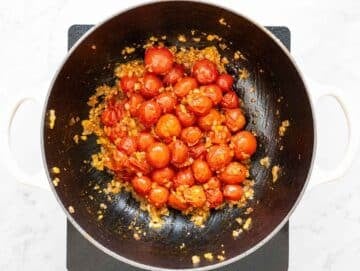 Step 2 Onion, garlic, oregano, and pepper flakes cooking with burst tomatoes.