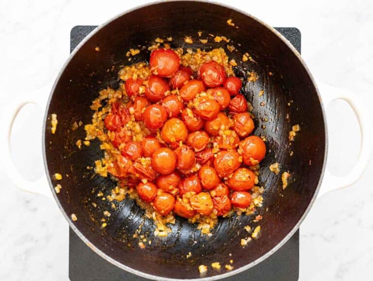 Step 2 Onion, garlic, oregano, and pepper flakes cooking with burst tomatoes.