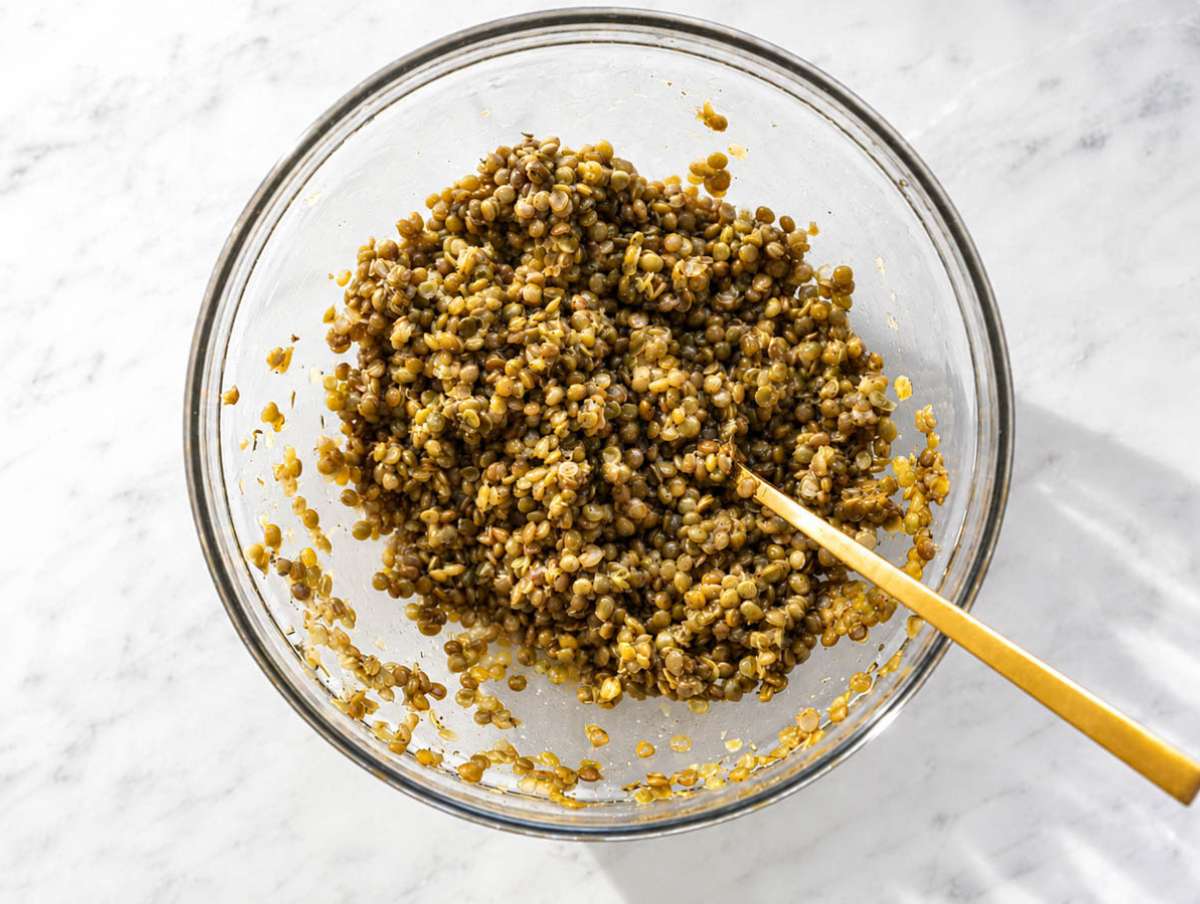 Step 2 Warm lentils tossed with glossy Dijon vinaigrette in a large mixing bowl.