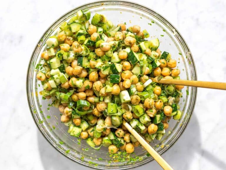 Step 3 Adding cucumber, celery, green onions, and parsley to marinated chickpeas.