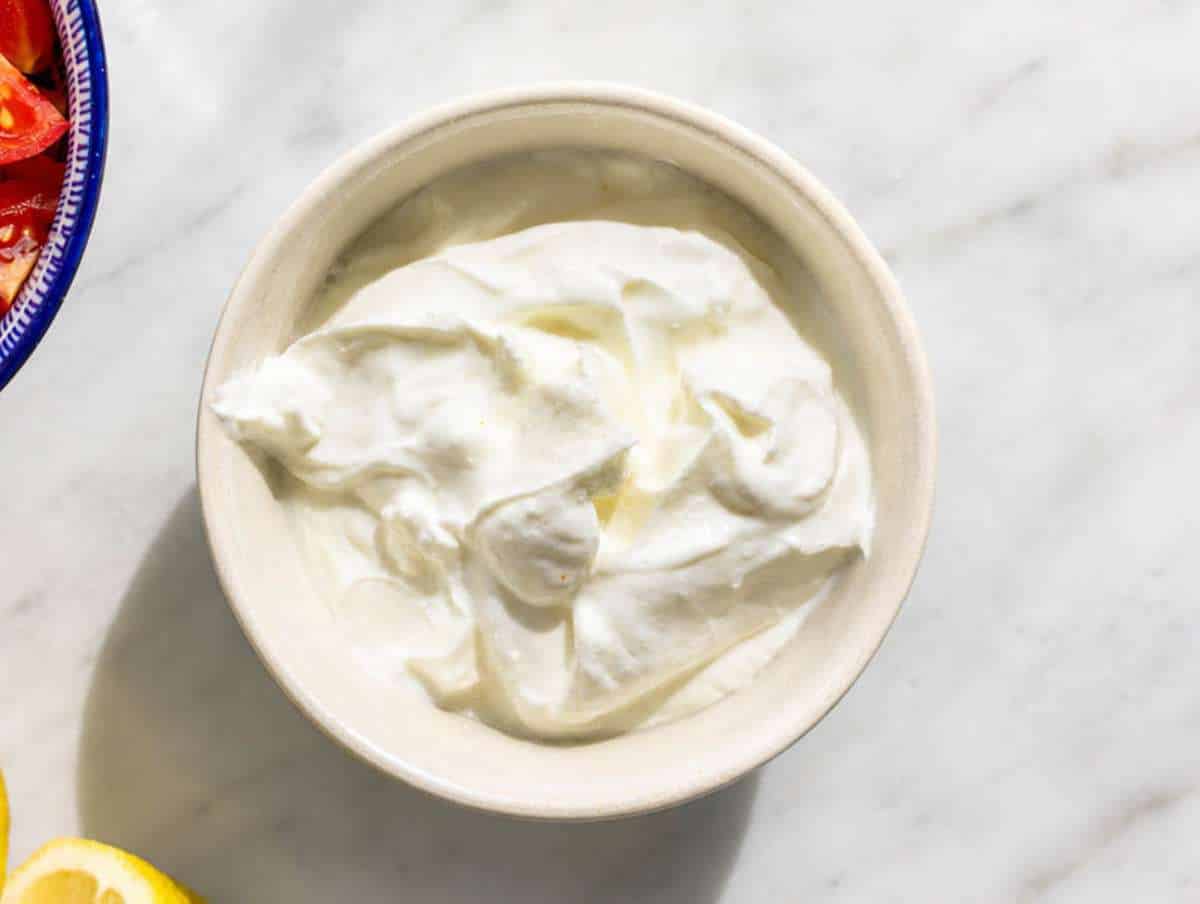 Step 3 Greek yogurt mixed with garlic, lemon juice, salt, and water until smooth.