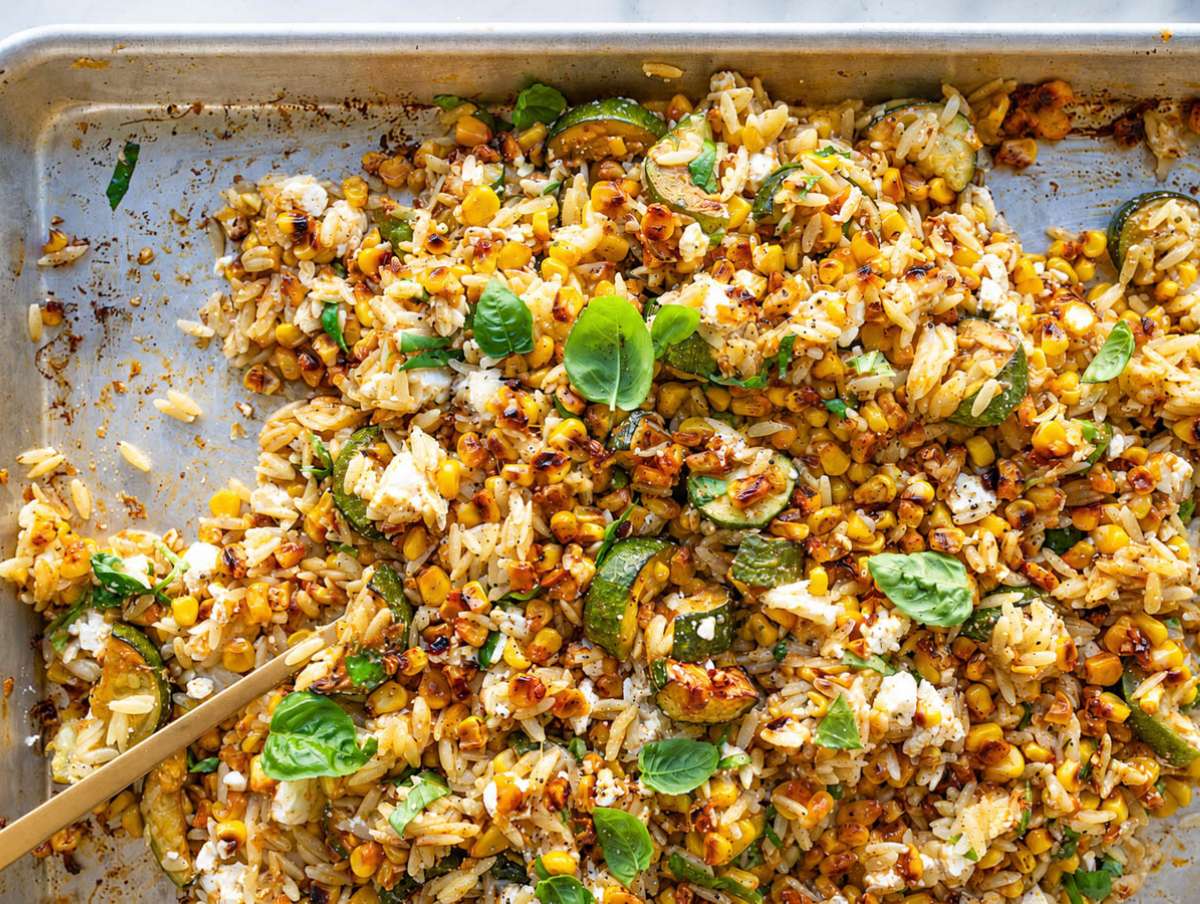 Step 3 Hot orzo tossed with roasted vegetables, feta, basil, and lime dressing.
