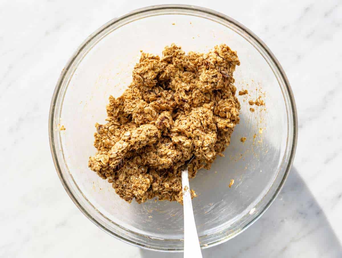 Step 3 Mixing oat flour, oats, spices, and dates into thick cookie dough.