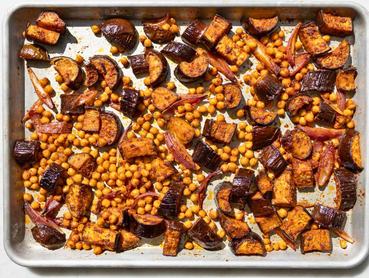 Step 3 Roasted eggplant, chickpeas, and onions caramelized on a sheet pan with browned edges.