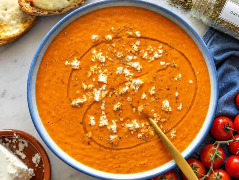 Step 3 Roasted tomato soup served in a blue bowl with crumbled feta.