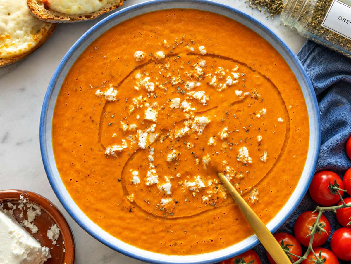 Step 3 Roasted tomato soup served in a blue bowl with crumbled feta.